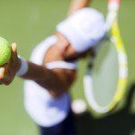 Female tennis player focus on serving and not on distractions.